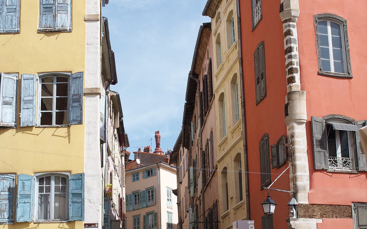 Les ruelles colorées du Puy-en-Velay et la vue sur la statue Notre-Dame-de-France